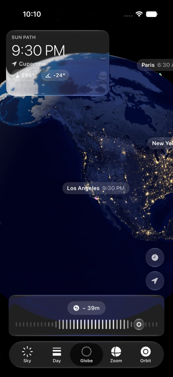 The Globe tab at 9:30 PM: the Earth from above Cupertino with the line of night across North America, the cities lit, Los Angeles 9:30 PM and Paris 6:30 AM on their pins, the sun's bearing and height, and the dial turned 39 minutes back